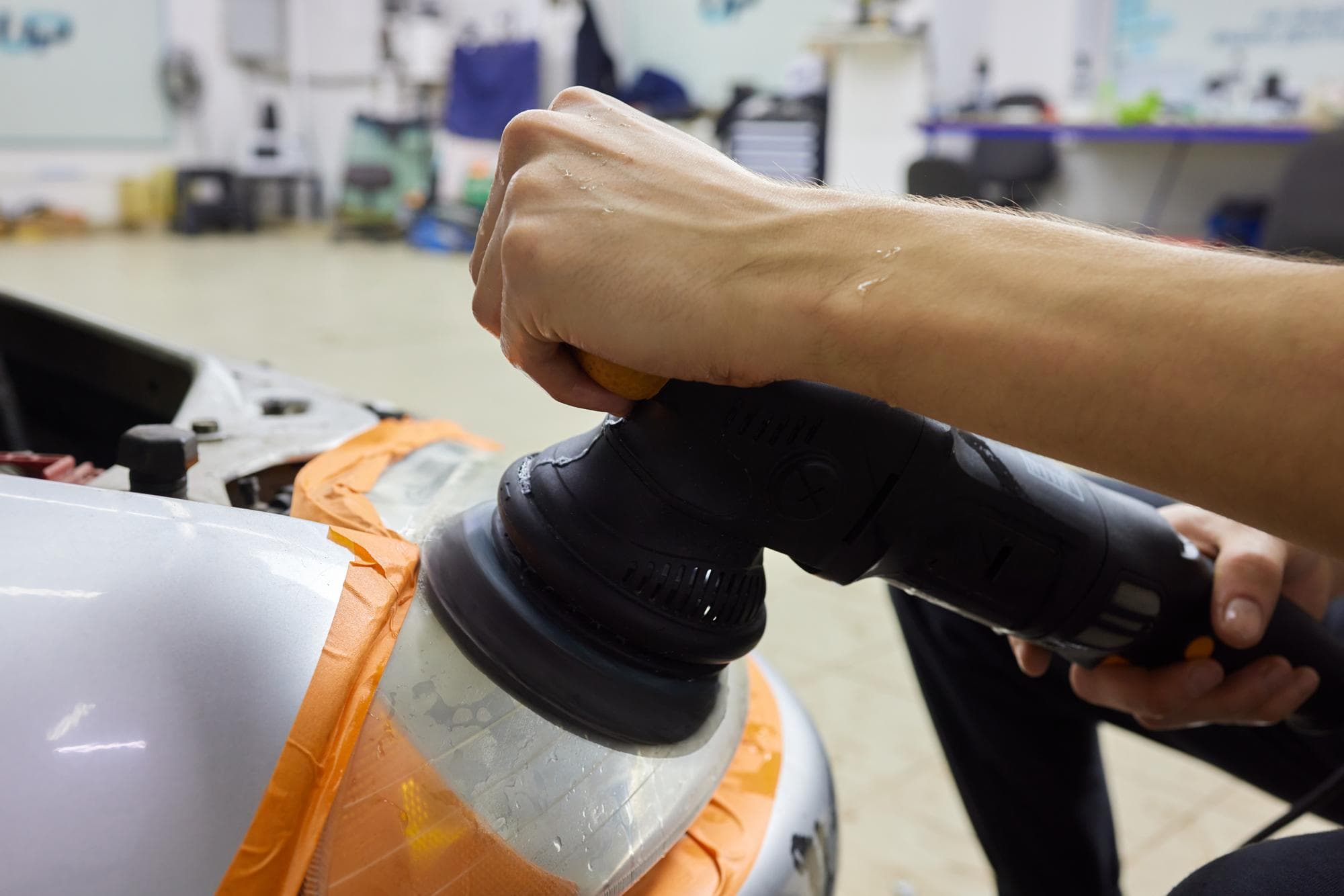 Machine polishing a car's paint to remove swirl marks