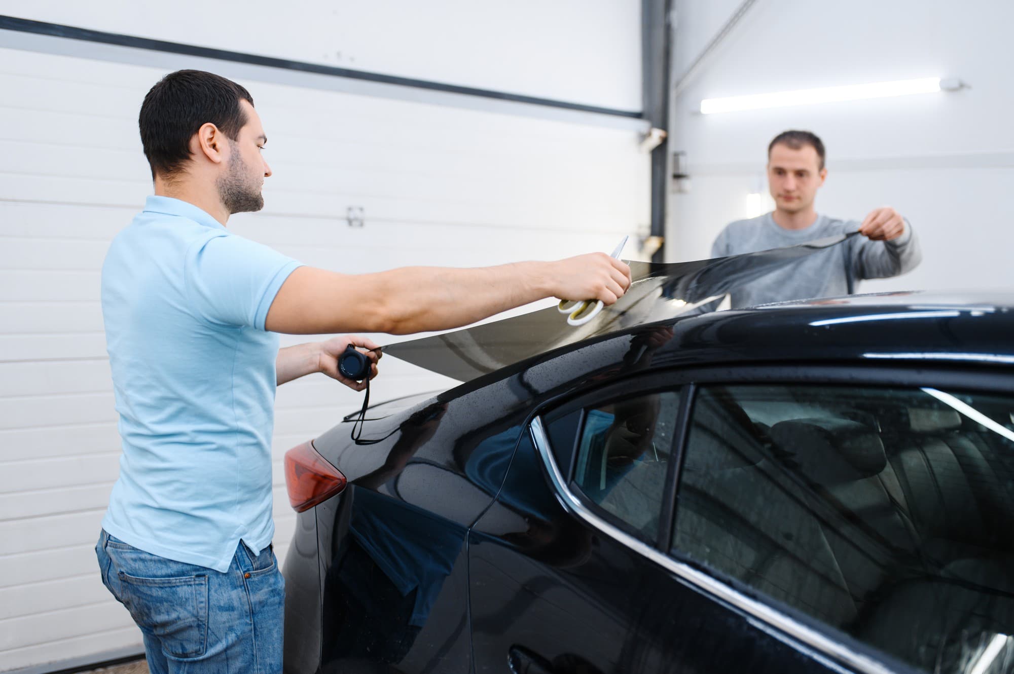 Window tint film being applied to a car window